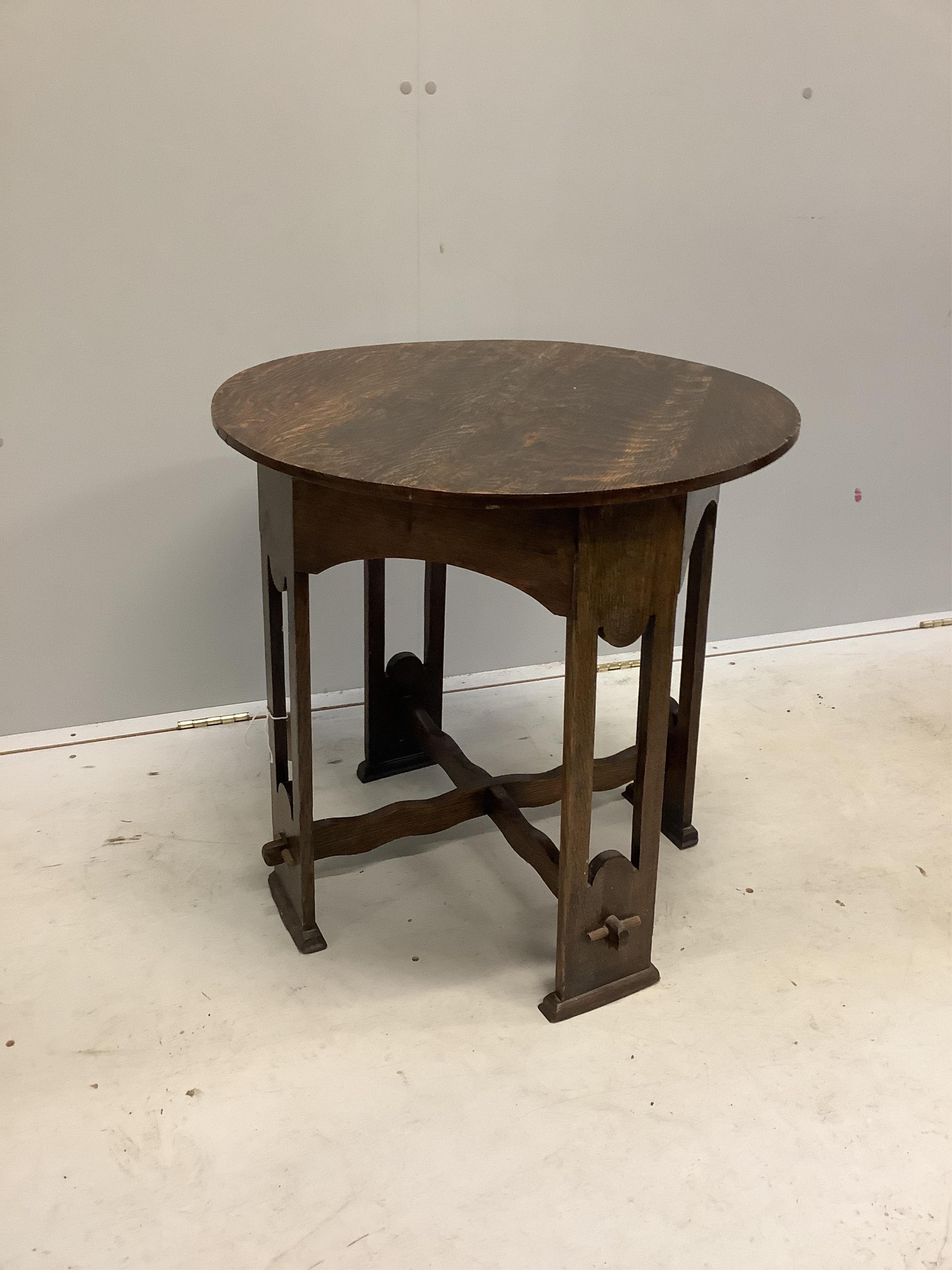 An Arts & Crafts circular oak occasional table, diameter 61cm, height 61cm. Condition - fair